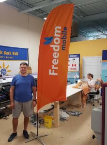 Orange feather flag on a cross base in a print shop