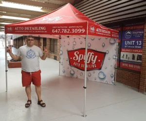 Red printed canopy tent with a printed back wall, indoors