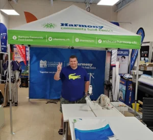 Green and white printed canopy tent with a blue back wall in a print shop
