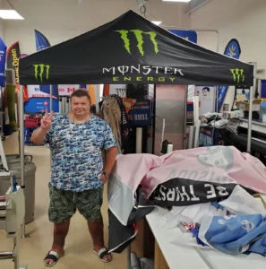 Black printed canopy tent with green lettering in a print shop