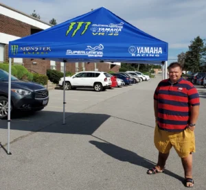 Blue printed canopy tent set up in a parking lot
