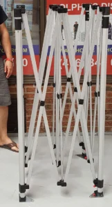 Folded aluminum tent frame standing upright