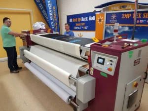 Canopy fabric running through a dye-sublimation heat press