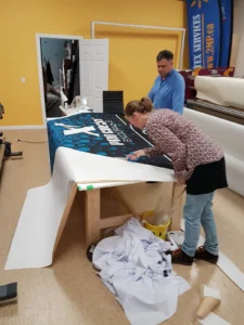 Printed canopy fabric being finished on a work table