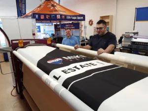 Black printed canopy fabric on a heat press roller