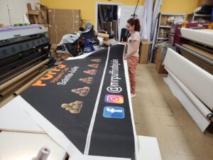 Printed canopy fabric laid out on a work table in a print shop