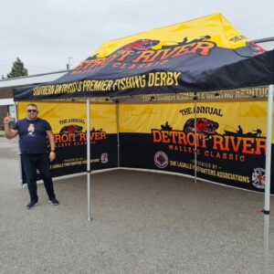Yellow and black printed canopy tent with printed back and side walls, outdoors