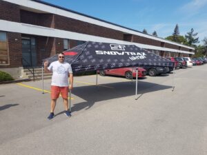 Black printed canopy tent set up in a parking lot