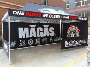 Black printed canopy tent with printed back and side walls, outdoors