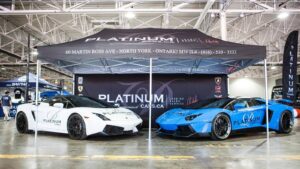 Black printed canopy tent over two cars at an indoor show