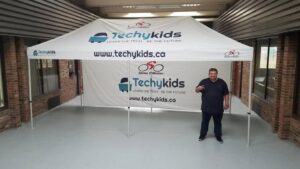 White printed canopy tent with a printed back wall, indoors