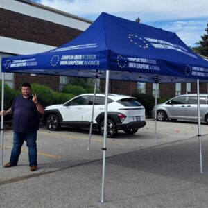 Navy printed canopy tent set up in a parking lot