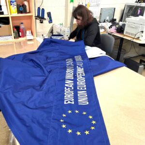 Navy printed canopy fabric being finished on a work table