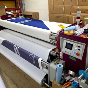 Printed canopy fabric rolls on a heat press