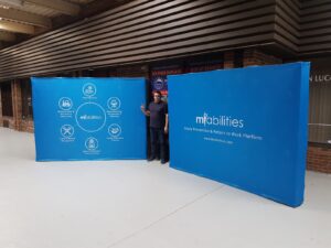 Man between two blue pop up fabric displays in the showroom