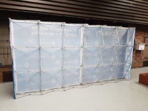 Back of a 16 ft pop up fabric display showing the expanded frame