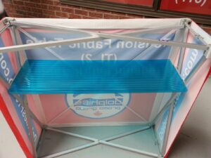Inside view of a pop up fabric counter with the blue shelf