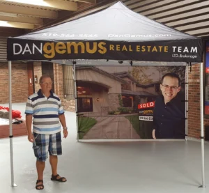 White and black printed canopy tent with a photo-printed back wall, indoors