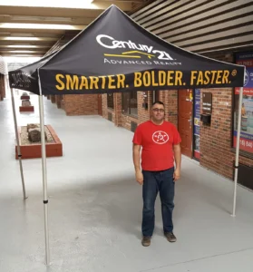 Black printed canopy tent with yellow lettering, indoors