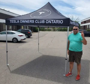 Black printed canopy tent set up in a parking lot