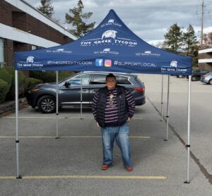 Navy printed canopy tent set up in a parking lot