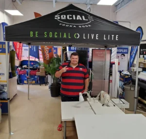 Black printed canopy tent with green lettering in a print shop