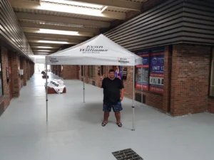 White printed canopy tent at the end of a long hallway