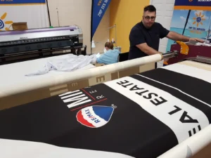 Black printed canopy fabric on a heat press roller