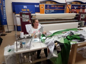 Canopy fabric being sewn at a sewing machine