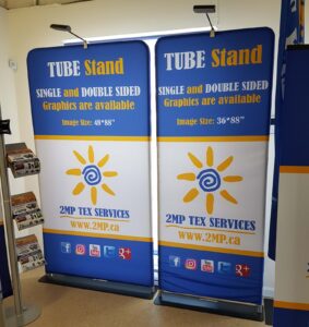 Two tube stands side by side with matching blue, white and yellow sun graphics