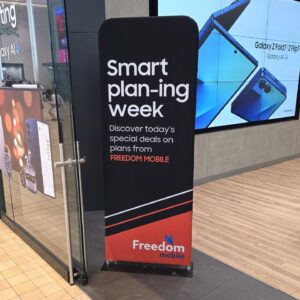 Black a 3 ft tube fabric display with a red bottom inside a phone store