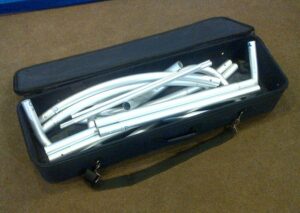 Soft carry bag opened, holding the aluminum tube frame