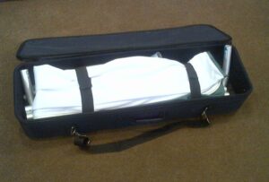 Soft carry bag opened, holding the folded fabric graphic and frame tubes